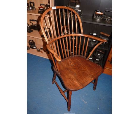 A solid Elm seated stick-back kitchen carver chair having bent-wood arms and supports, turned legs and stretchers. Good patin