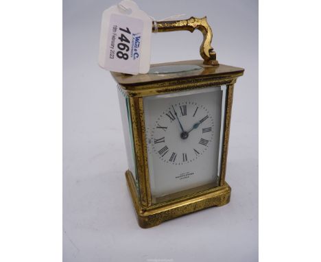 A brass cased, bevelled glass Carriage Clock, exa'd by Mappin &amp; Webb, London, the enamelled face with Roman numerals and 