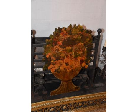 A decorative wooden fire screen in the shape of an urn with cottage garden flowers, 23" wide x 35" tall.