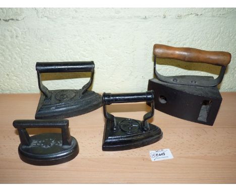 A group of four Irons including 'Main' No. 400 Gas Iron with a wooden handle, Hawkins &amp; Co. Tipton 1879 Flat Iron with Ba