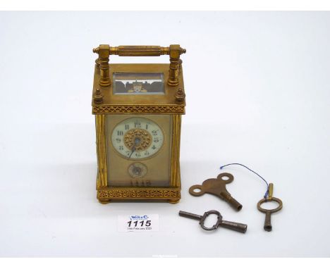 A small French travel clock c. 1880 with alarm and pierced decoration to the dials.