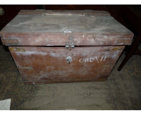 A very large heavy leather Trunk with wooden strut, leather straps and metal base, 27" x 18" x 17 1/2".