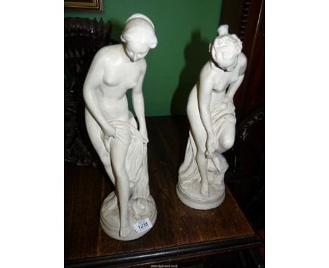 A pair of plaster mantel ornaments depicting female Nudes, 16 3/4'' and 17 1/4'' tall respectively, stamped "42" to the circu