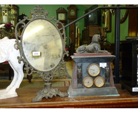 An oval Dressing Mirror in ornate brass frame and stand, plus an Egyptian theme mantle Clock in slate and marble with metal S