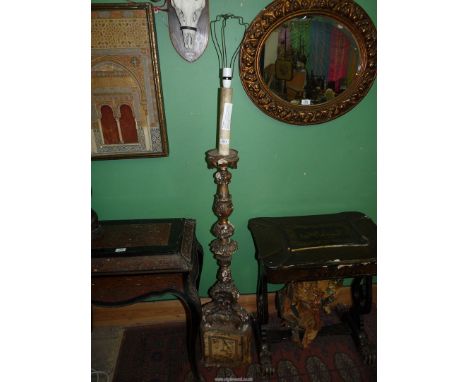 An carved wood and gesso floor standing Lamp with signs of formerly being gilded, 46 3/4'' high to bulb holder.