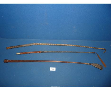 A wooden Riding stick/crop made from twisted cane a/f., 31" long, together with a leather riding crop, 27 1/2" long and anoth