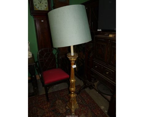 A giltwood Floor Lamp having a lobed urn base raised on a triple paw footed plinth and with a tapering turned and fluted pill