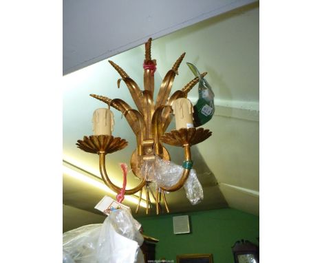 A gilded metal double wall-light with foliage, seed heads and candle style lamp holders, 15" high, 10" wide approximately and