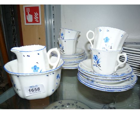A small quantity of "Victoria" teaware, white ground with blue flowers compirsing four cups, six saucers, six teaplates, cake