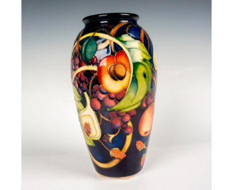 Navy blue ground glazed vase with peaches, grapes, and figs. Detailed tube lining. Inspired by Titania's words in A Midsummer
