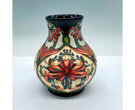 A stunning dark navy-blue and cream-colored ground vase with beautiful pink Wild Bergamot-like flowers and fine tube lining. 