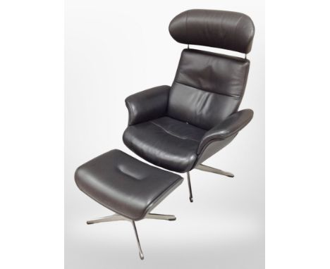 A late 20th century black stitched leather swivel manual reclining armchair and matching footstool on chrome support 