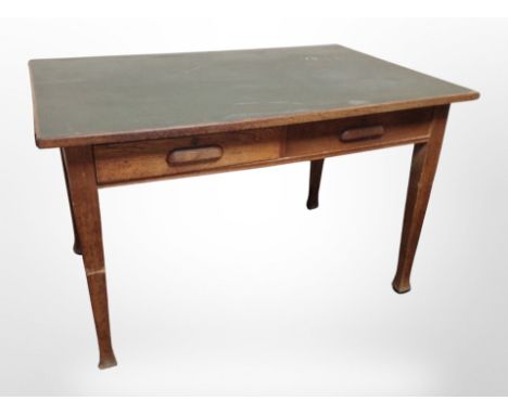 A 1930's oak library table fitted two drawers, width 125cm 