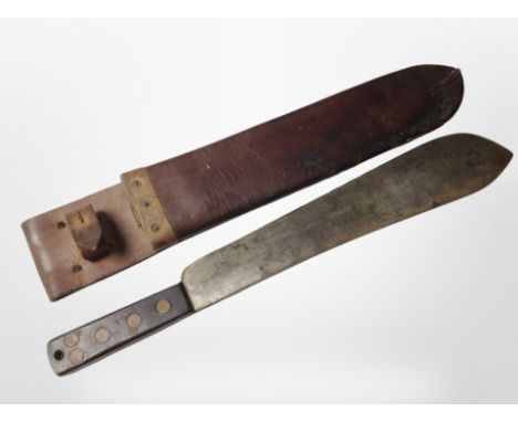 A British military machete by Martindale, stamped with War Department broad arrow and dated 1952, in leather sheath.