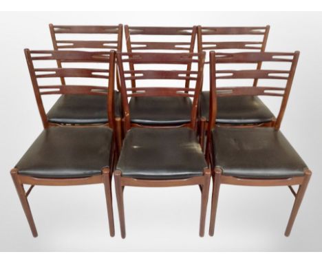 A set of six reproduction teak ladder back dining chairs with black vinyl seats 