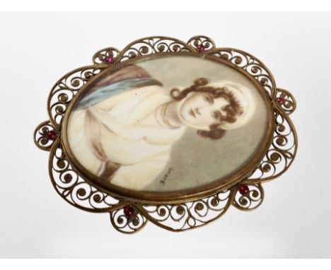 A 19th century portrait miniature of a lady wearing a bonnet in brass scrollwork frame, 11cm x 9cm overall, monogram to rever