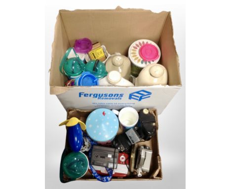 Two boxes containing antique stoneware bottles, vintage Ambassador handheld camera, modern household wares.