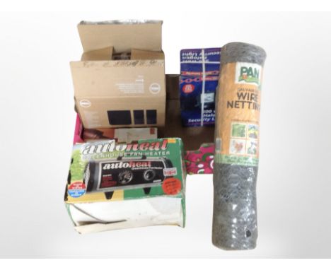 A box containing security light, heater, a roll of chicken wire, etc.