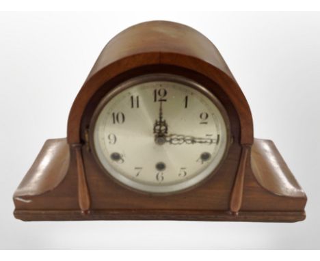 A walnut-cased mantel clock with silvered dial.