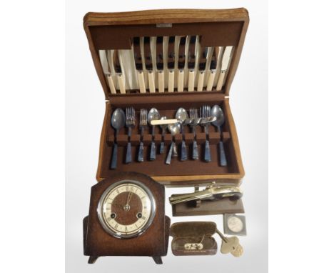 An oak canteen of cutlery, together with an oak mantel clock, pair of antique spectacles, table lighter in the form of a flin