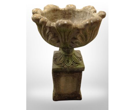A weathered concrete garden planter on associated stand, height 77 cm 