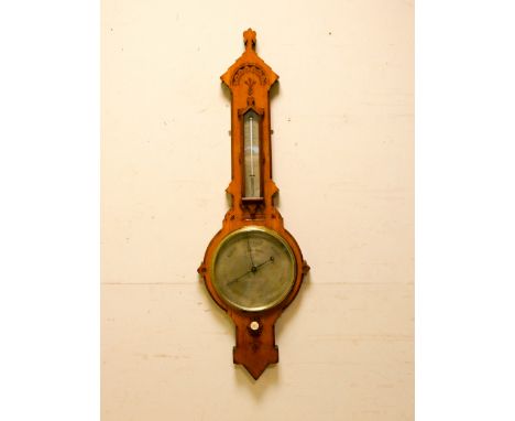 An Edwardian Arts and Crafts style barometer in carved light oak case by Negretti and Zambra 