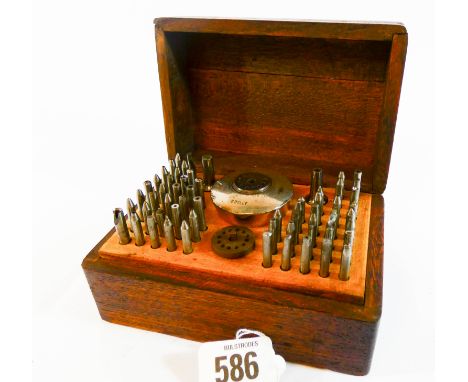 A small oak box measuring 13cms x 9cms containing a group of watchmakers tools etc 