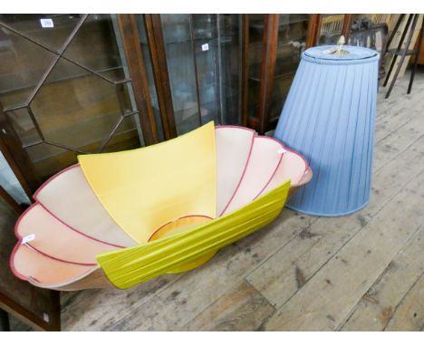 A large blue shaped material lamp shade and bath shaped shade