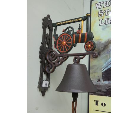 A cast iron wall hanging bell with steam engine top 