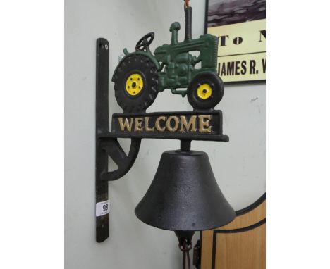 A cast iron wall hanging with tractor top and 'Welcome'