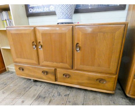 A light elm Ercol three door side board with two drawers under 51" wide 