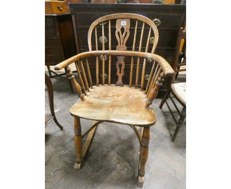 An antique elm hooped stick backed rocking Windsor elbow chair 