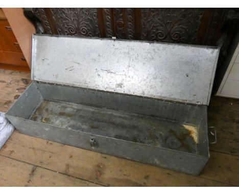 A long galvanized metal tin trunk 