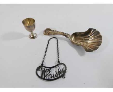 Silver antique caddy spoon, silver Whisky decanter label and a miniature novelty cup.