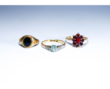 Three 9ct gold ladies dress rings, set with onyx, garnet and blue stone.