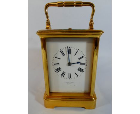 A French gilt brass carriage clock with striking mechanism, height with the handle up 18cm   Glazing as found 
