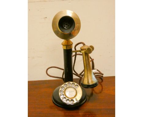 An old Bakelite and brass stick telephone 