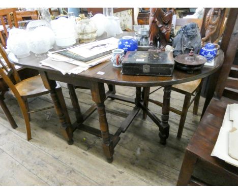 A reproduction oak oval gate leg dining table on turned legs 3'6 wide  