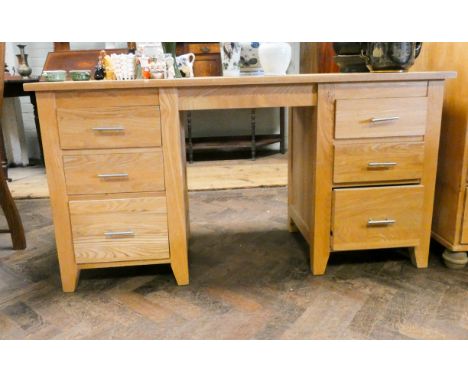 A modern light oak kneehole desk fitted six drawers 58" wide  