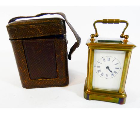 A miniature gilt brass carriage clock with leather travelling case, height with the handle up 9.5cm 