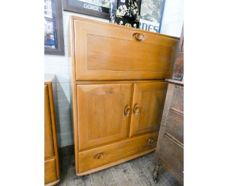 A light elm Ercol bureau cabinet fitted cupboards and one long drawer under 32 1/2" wide 