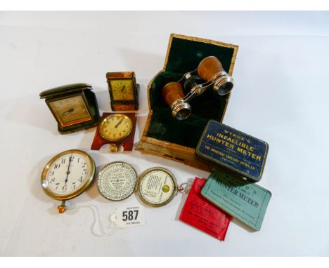 A pair of snakeskin covered binoculars together with four travelling watches and a light metre in its original box with paper