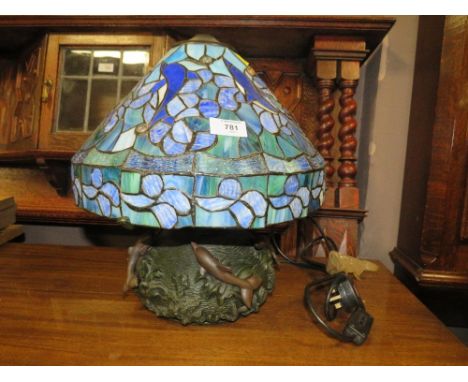 A TIFFANY STYLE TABLE LAMP WITH A BRONZED STYLE DOLPHIN BASE A/F H-38 CM (OVERALL)