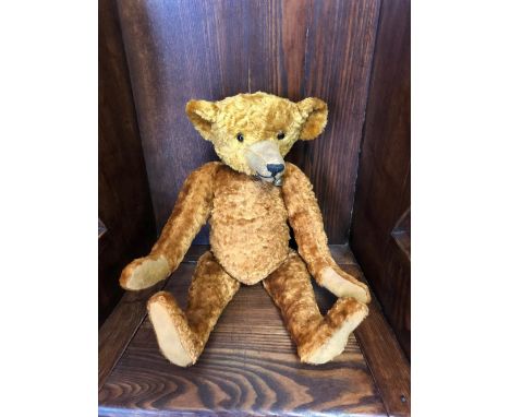 A 1920s STYLE&nbsp;GERMAN TEDDY BEAR IN THE MANNER OF STEIFF, with glass eyes, long nose and hunchback.