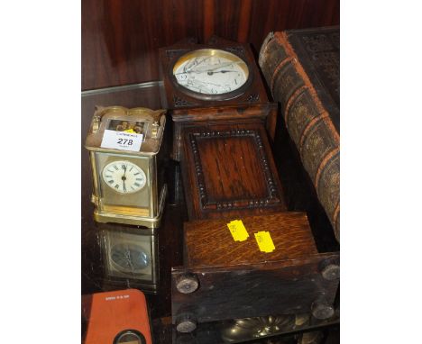 A VINTAGE BRASS CARRIAGE CLOCK, MISSING SIDE PANEL, TOGETHER WITH A CARVED OAK MINIATURE LONG CASE CLOCK, GLASS BROKEN