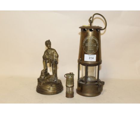AN ECCLES TYPE 6 MINERS LAMP TOGETHER WITH A SMALLER EXAMPLE AND A BRASS MINOR FIGURE