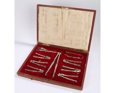 Impressive Victorian plated and cased nut cracker set, with six nut crackers, a larger pair, grape scissors and tongs housed 