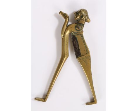 Indian brass figural betel nut cracker, in the form of a figure with hands pressed together with dividing legs to form the cr