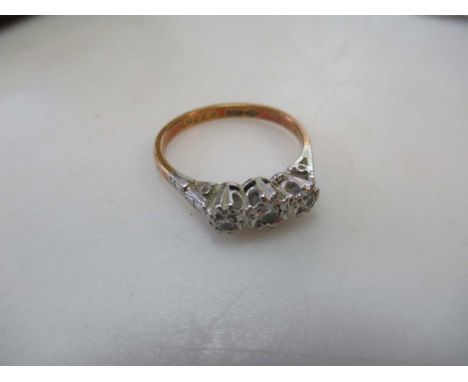 A three stone diamond ring, estimated approximate total diamond weight 0.10ct, stamped '18CT', weight 2.7g