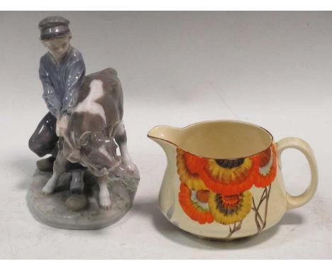 A Royal Copenhagen boy with a cow together with a Clarice Cliff Rodanthe pattern milk jug (2)